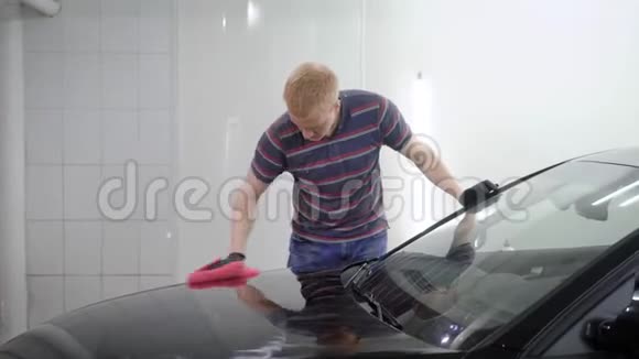 红发男工在车上用磨光机加工汽车表面覆盖保护层视频的预览图