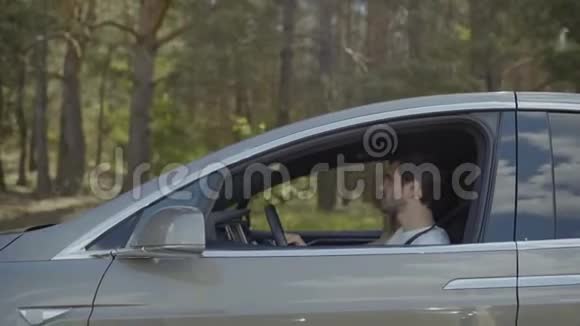 年轻的恋爱中的情侣在开车旅行时开玩笑视频的预览图