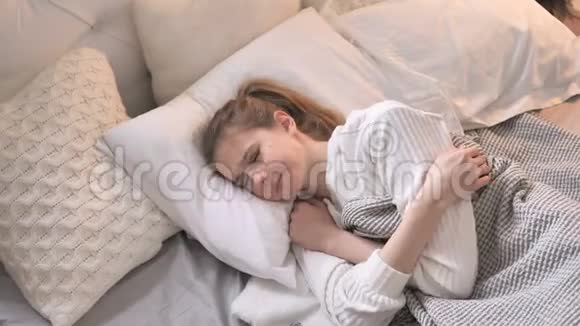 有头痛的少女躺在床上视频的预览图