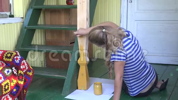 女村民妇女用刷子在农村花园房里画杆4K视频的预览图