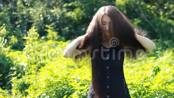 风和日丽的夏日年轻美丽的女人梳着长发视频的预览图