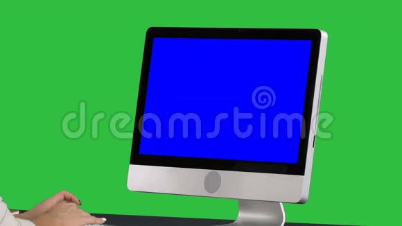 女人在绿色屏幕上使用电脑Chroma键蓝色屏幕模拟显示视频的预览图