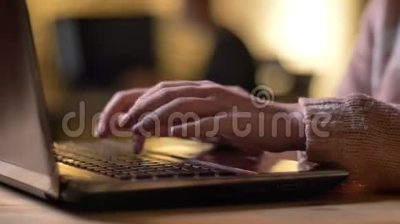 在办公室背景的笔记本电脑上输入女性手的特写肖像视频的预览图