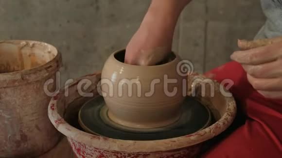 女性的手在陶轮上塑造粘土花瓶视频的预览图