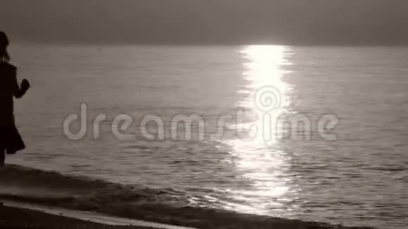 一位走在海边的女士的剪影视频的预览图