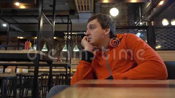 一个人坐在咖啡馆里等待他的命令视频的预览图