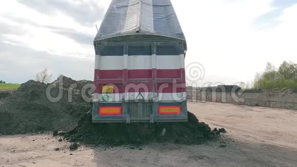 卡车在特别储存地点卸下污染石油的泥土或沙子视频的预览图