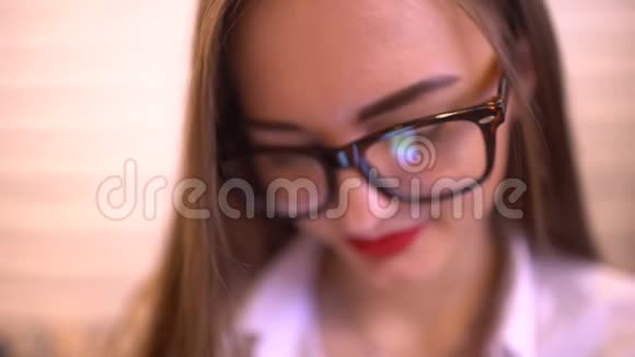 女士戴着眼镜和使用手机手机在眼镜中的反射显示4k关闭视频的预览图