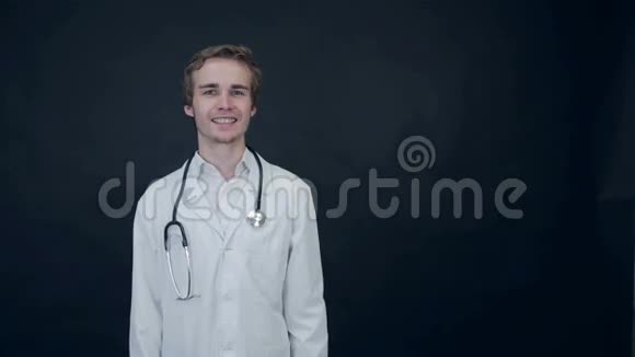 微笑医生竖起大拇指站在黑色的背景上包装好的视频的预览图