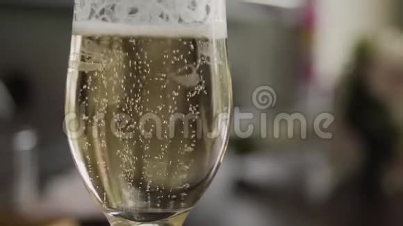 金色的结婚戒指掉进一杯香槟里视频的预览图