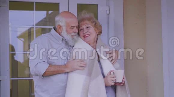 幸福的老夫妇在他们家的门廊视频的预览图