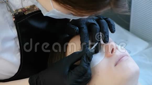 美容师把睫毛分开弯成卷发器肉毒杆菌和睫毛层压视频的预览图