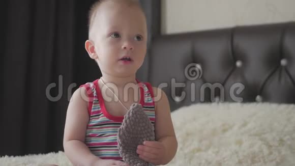 小帅哥在家抱一只毛绒兔子室内小男孩玩玩具视频的预览图