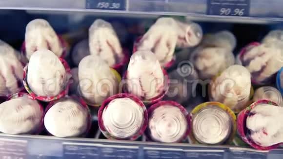 把超市货架上一个冰淇淋的镜头非常接近女性手工顾客吃冰淇淋视频的预览图
