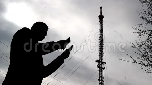一个有两部电话的男人正在寻找一个价格低廉的电话塔背景网络这是一个糟糕的信号视频的预览图