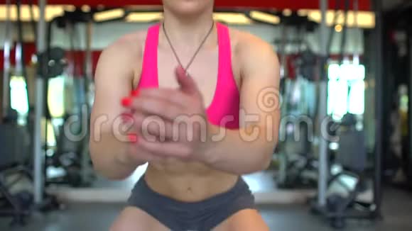 在健身房做仰卧起坐运动的女运动员肌肉发达的年轻女人在蹲体育美容健身的概念视频的预览图