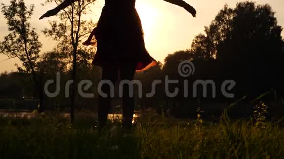 无忧无虑的女人在夕阳下翩翩起舞的身影视频的预览图