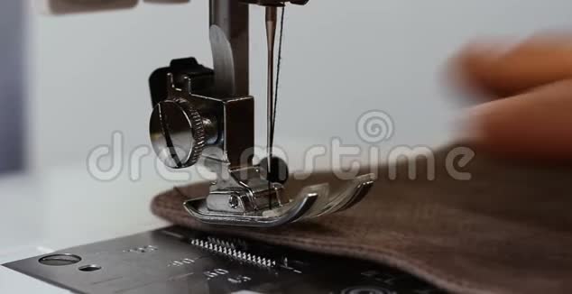 女裁缝手拿布缝纫机视频的预览图