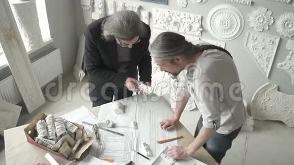 两位建筑师正在与创意项目合作站在明亮的办公室视频的预览图
