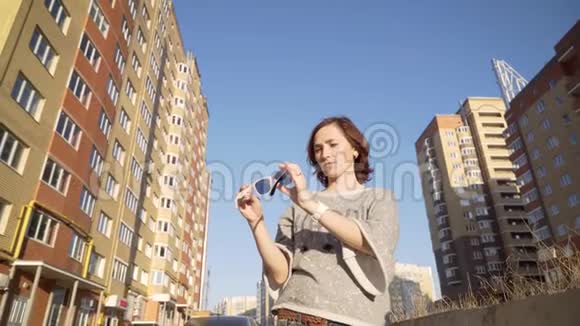 高层建筑背景下的一位女士戴着太阳镜视频的预览图