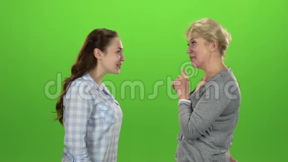 女人把钥匙给她女儿绿色屏幕侧视慢动作视频的预览图