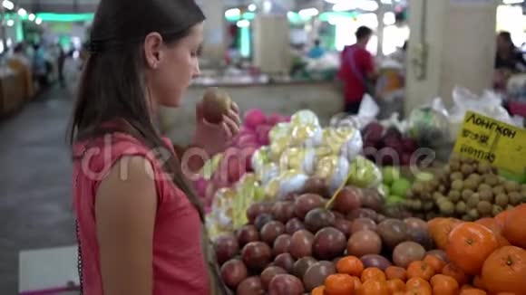 女孩在市场上选择新鲜水果视频的预览图