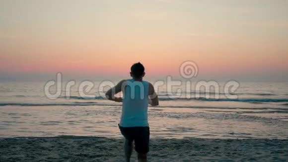 快乐的人跑得很快日落时分在海边的海边跳得很高视频的预览图