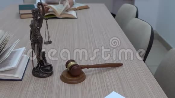 一名律师在工作场所审查文件和立法Themis的小雕像和总计划视频的预览图