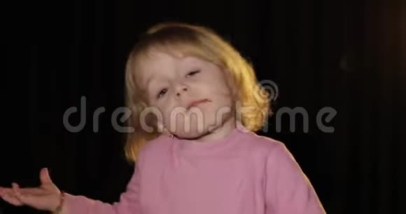 可爱的孩子吃了一大块巧克力可爱的金发女孩视频的预览图