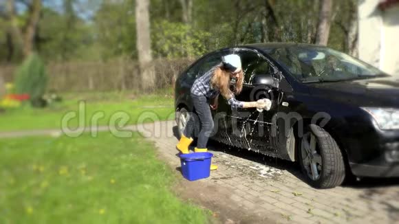 女孩用肥皂海绵洗黑车视频的预览图