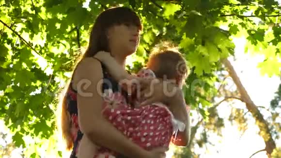 年轻妈妈拥抱小女儿亲吻和微笑视频的预览图