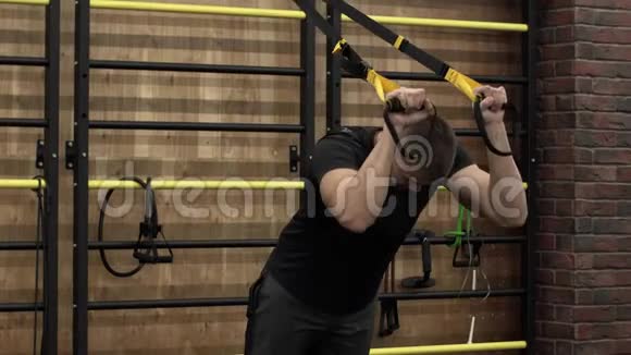 侧视强壮的年轻男性成人在健身房工作视频的预览图