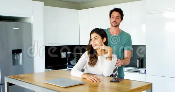 男人在厨房按摩女人的肩膀视频的预览图