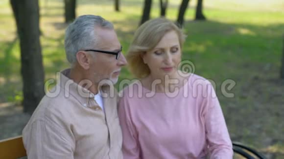 退休夫妇在公园用智能手机自拍度假记忆视频的预览图