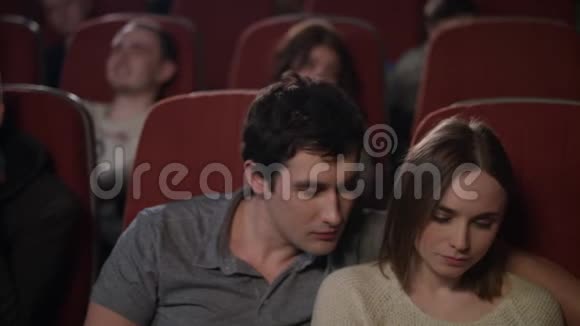在电影院和男朋友在智能手机上自拍的女孩视频的预览图