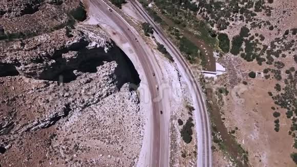 俯视空中拍摄美丽的公路公路和铁路轨道之间惊人的岩石砂岩山脉视频的预览图