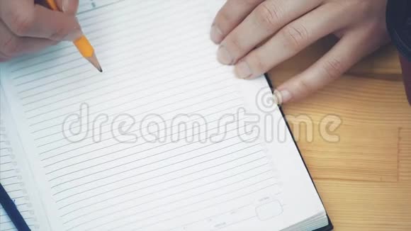 用铅笔在笔记本上特写女性手记策略新商业计划的女商人视频的预览图