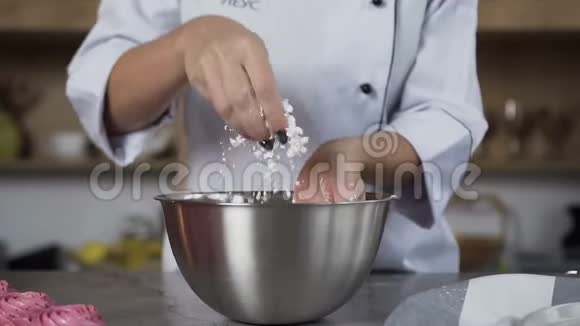 女性糖果师在做蛋糕的时候把糖粉扔进盘子里视频的预览图