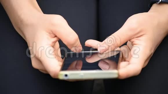 手指在女人手中的手机上发短信视频的预览图