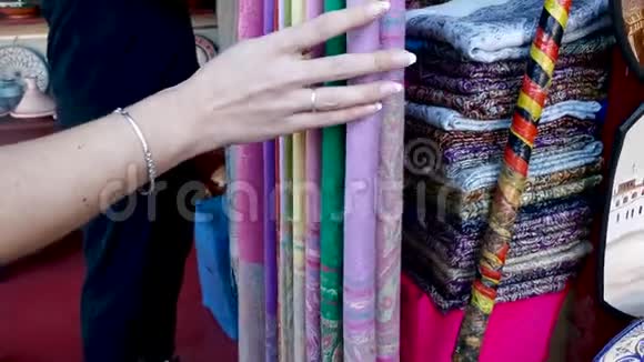 女孩购物检查纺织品中央广场市场摊档摩洛哥马拉喀什视频的预览图