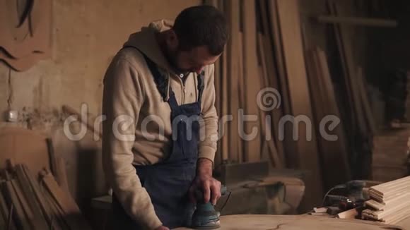 他的小作坊里的木匠正在打磨这块木头桑德瞄准射击视频的预览图