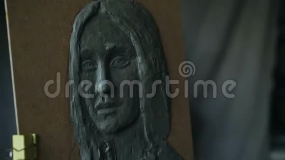 雕塑家的特写镜头在艺术工作室画布上创作女性面部雕塑视频的预览图