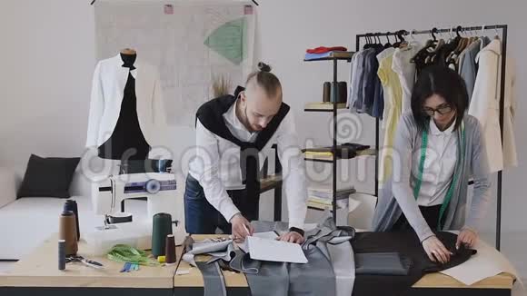 服装设计师和服装设计师在现代的小阁楼开发了一套新的服装成功视频的预览图
