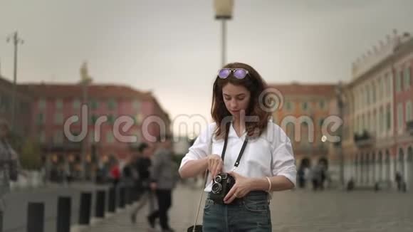 迷人的女摄影师用老式相机拍摄法国尼斯视频的预览图