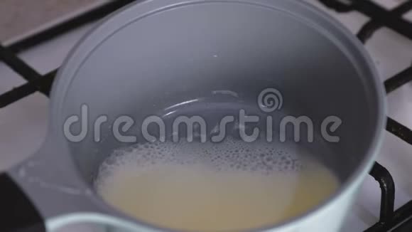 在煤气炉上用平底锅煮奶油视频的预览图