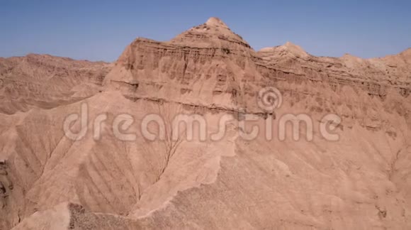 在沙漠中的空中飞行越过尖锐的沙质悬崖山脉视频的预览图