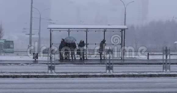 人们A在冬天在公共汽车站等公共汽车视频的预览图