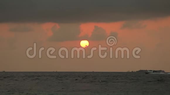 美丽的日落越过海洋在地平线上乘风破浪红色的太阳在水中反射天空中的云视频的预览图
