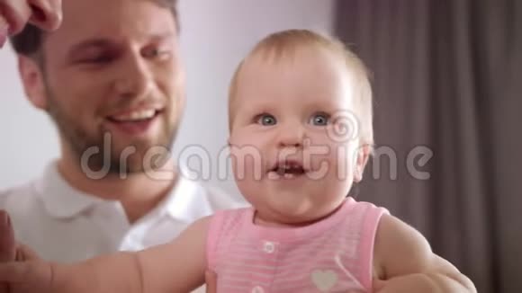 可爱的女婴被父亲拥抱幼儿与爸爸妈妈玩耍的肖像视频的预览图