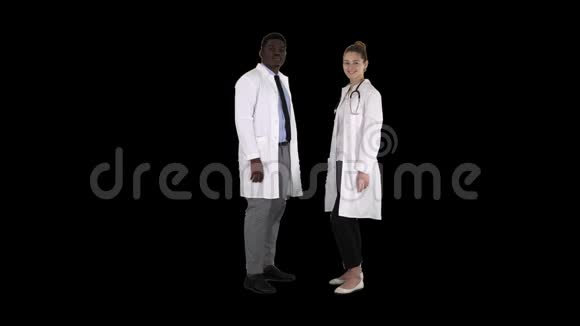 两位白种人和美国黑人微笑医生站在镜头前阿尔法频道视频的预览图